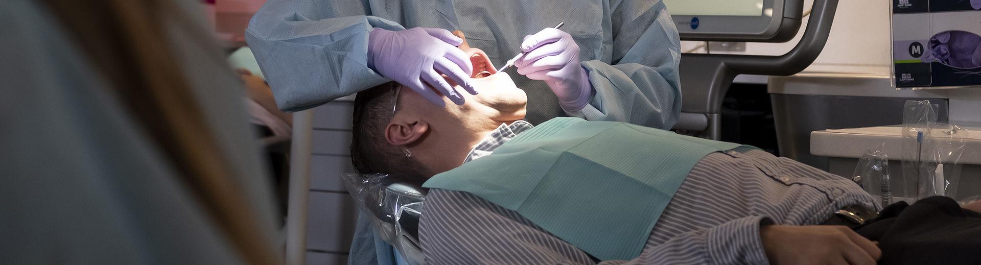 A male dental patient being treated in a clinic in the Kornberg School of Dentistry.